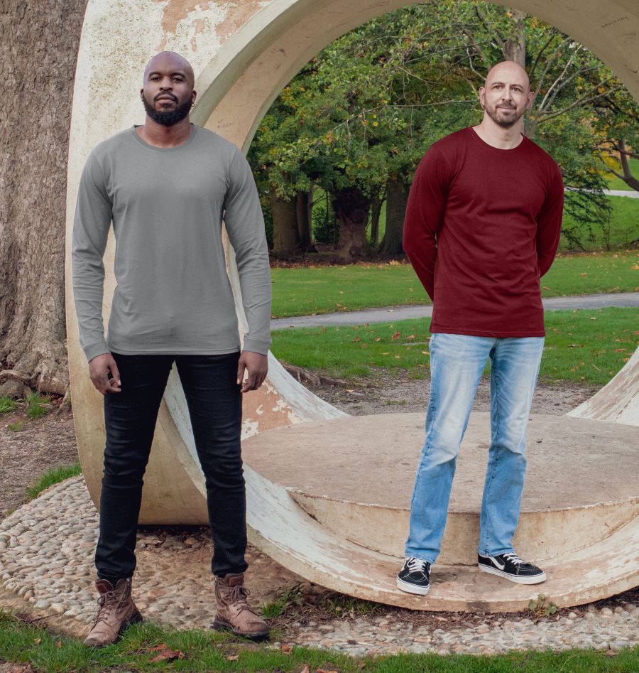 Two tall slim guys wearing maroon and light grey extra long long sleeve t-shirts and standing in a park.